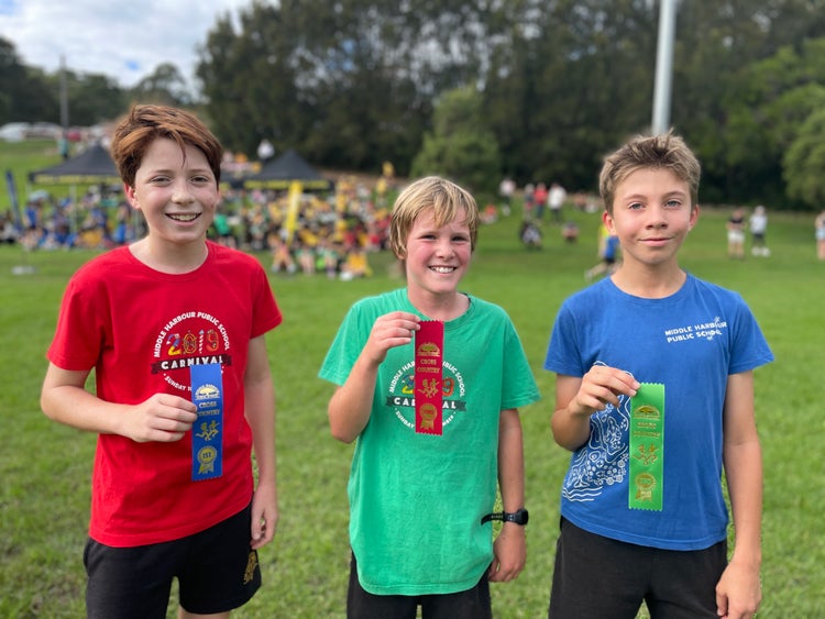 3 students with ribbons at cross country